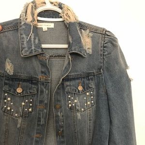 Ripped denim jacket with pearl accents